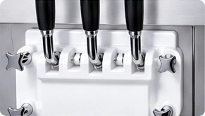 Cleaned dispensing handles are reassembled on the machine.