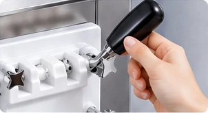 A hand removes a dispensing handle from the machine.